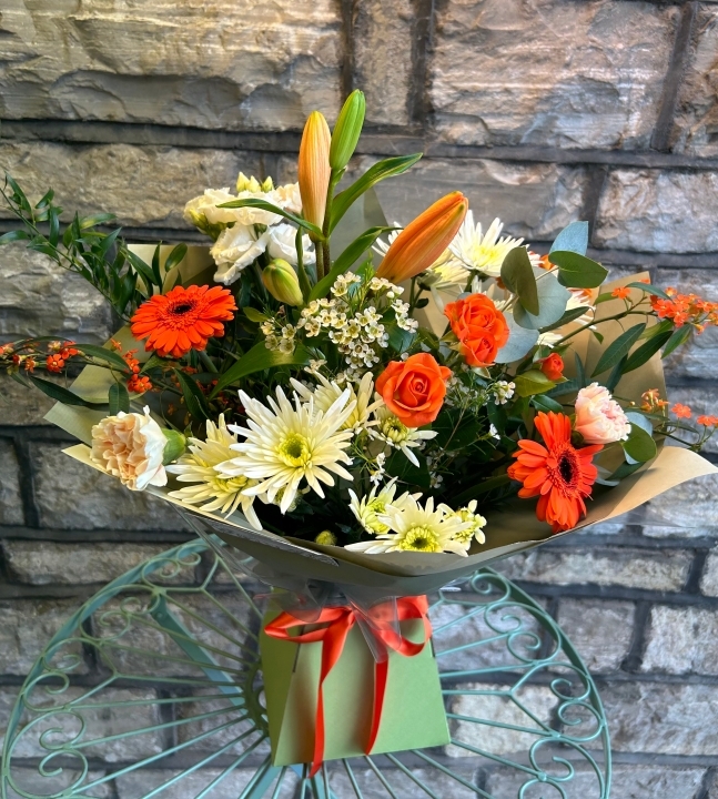 Florist choice seasonal hand tied bouquet orange, white, cream